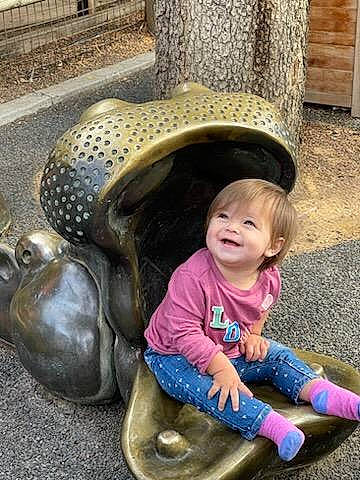 Braelyn joined the competition — help win amazing prizes! art, automotive_tire, automotive_wheel_system, child, city, fun, grass, happy, hat, head, joy, leisure, mammal, person, photograph, sculpture, sitting, smile, sun_hat, toddler