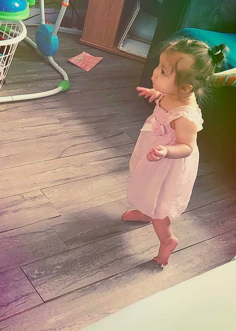 Brynlee joined the competition — help win amazing prizes! baby, baby_toddler_clothing, barefoot, day_dress, dress, floor, flooring, foot, fun, green, happy, hardwood, human_leg, leisure, person, pink, play, room, sitting, toddler