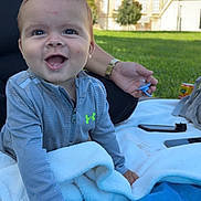 Ilyass participe au concours pour gagner de l'argent avec cette photo : baby, child, smiling, outdoor, grass, blanket, pacifier, person, hand, clothing, building, daylight, happy, face, crawling, jacket, nature, park, blue_sky, relaxation