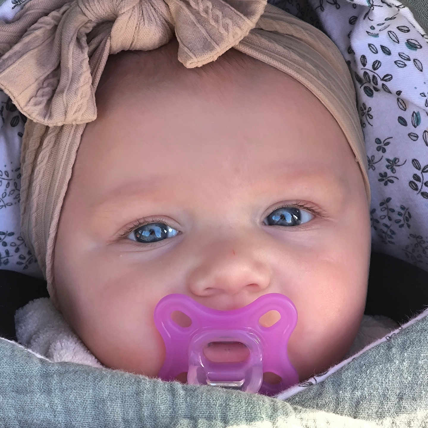 Alma a rejoint le concours — aidez-le/la à gagner de superbes lots ! adorable, baby, blanket, blue_eyes, bow, child, close_up, cute, face, headband, human, indoors, infant, pacifier, peaceful, portrait, skin, small_person, soft_texture, wrapped