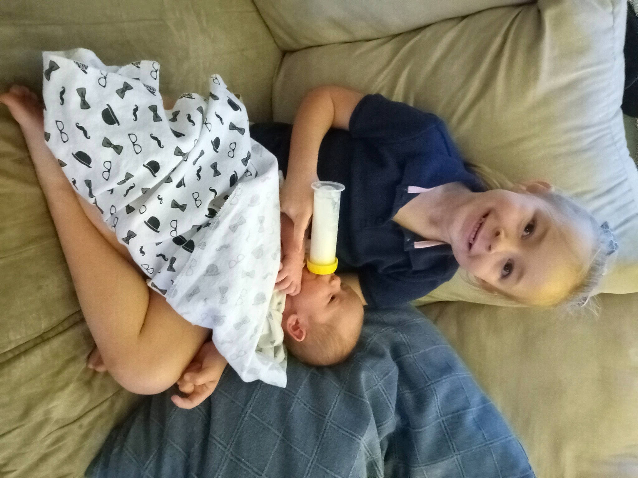 Paisley Rae joined the competition — help win amazing prizes! baby_toddler_clothing, child, comfort, couch, elbow, finger, gesture, glasses, happy, human_leg, joint, joy, neck, person, room, sitting, sleeve, smile, t_shirt, textile