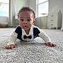 Kai joined the competition — help win amazing prizes! baby, infant, child, carpet, tuxedo, bow_tie, crawling, eyes, expression_surprised, onesie, indoor, room, dresser, window, natural_light, portrait, close_up, hands, curly_hair, soft_texture