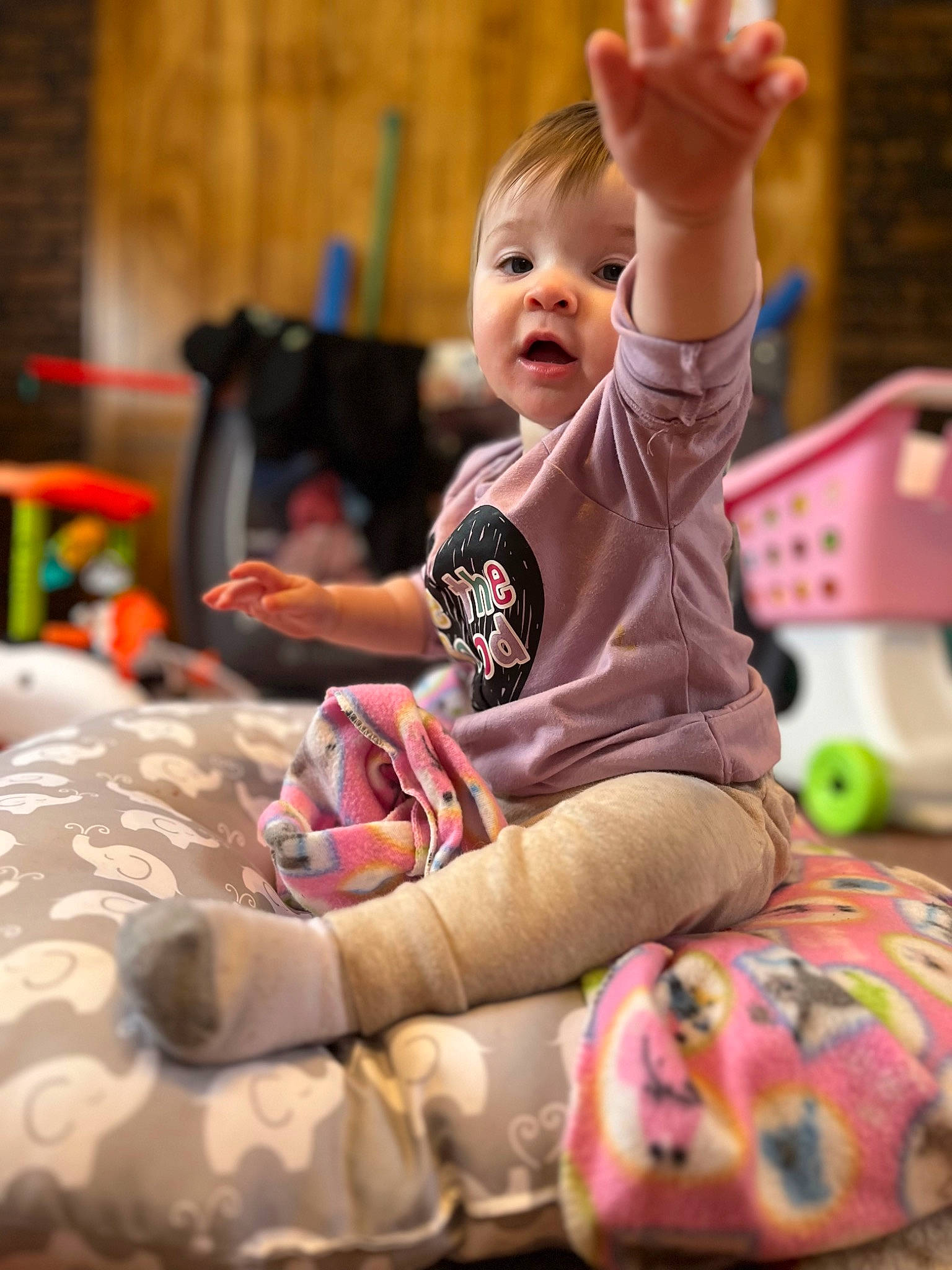 Claire is registered to the contest to win money with this photo: arm, baby, child, comfort, event, facial_expression, finger, fun, hand, happy, head, leisure, magenta, person, pink, play, recreation, sitting, smile, t_shirt