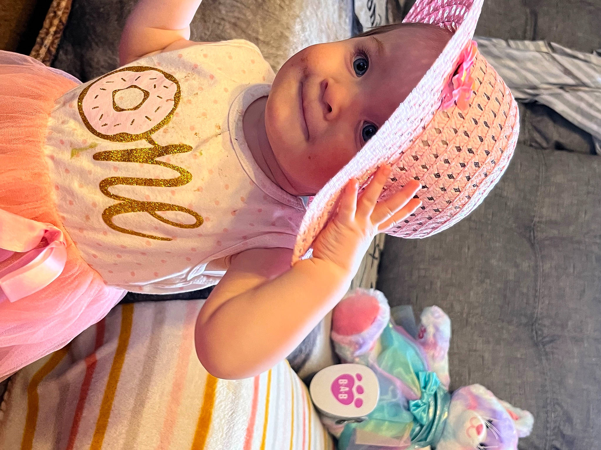 Claire is registered to the contest to win money with this photo: baby, baby_toddler_clothing, cap, child, fashion_accessory, fun, happy, hat, headgear, headwear, leisure, nail, pattern, person, pink, play, skin, smile, sun_hat, toddler