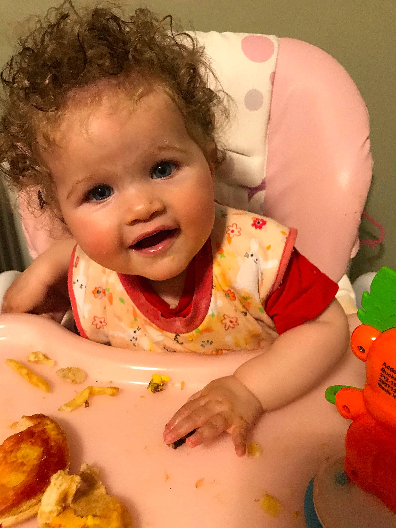 Adelaide is registered to the contest to win money with this photo: baby, baby_toddler_clothing, cheek, child, comfort_food, cuisine, dish, dress, facial_expression, food, food_craving, fun, happy, lip, mouth, orange, person, skin, smile, sweetness
