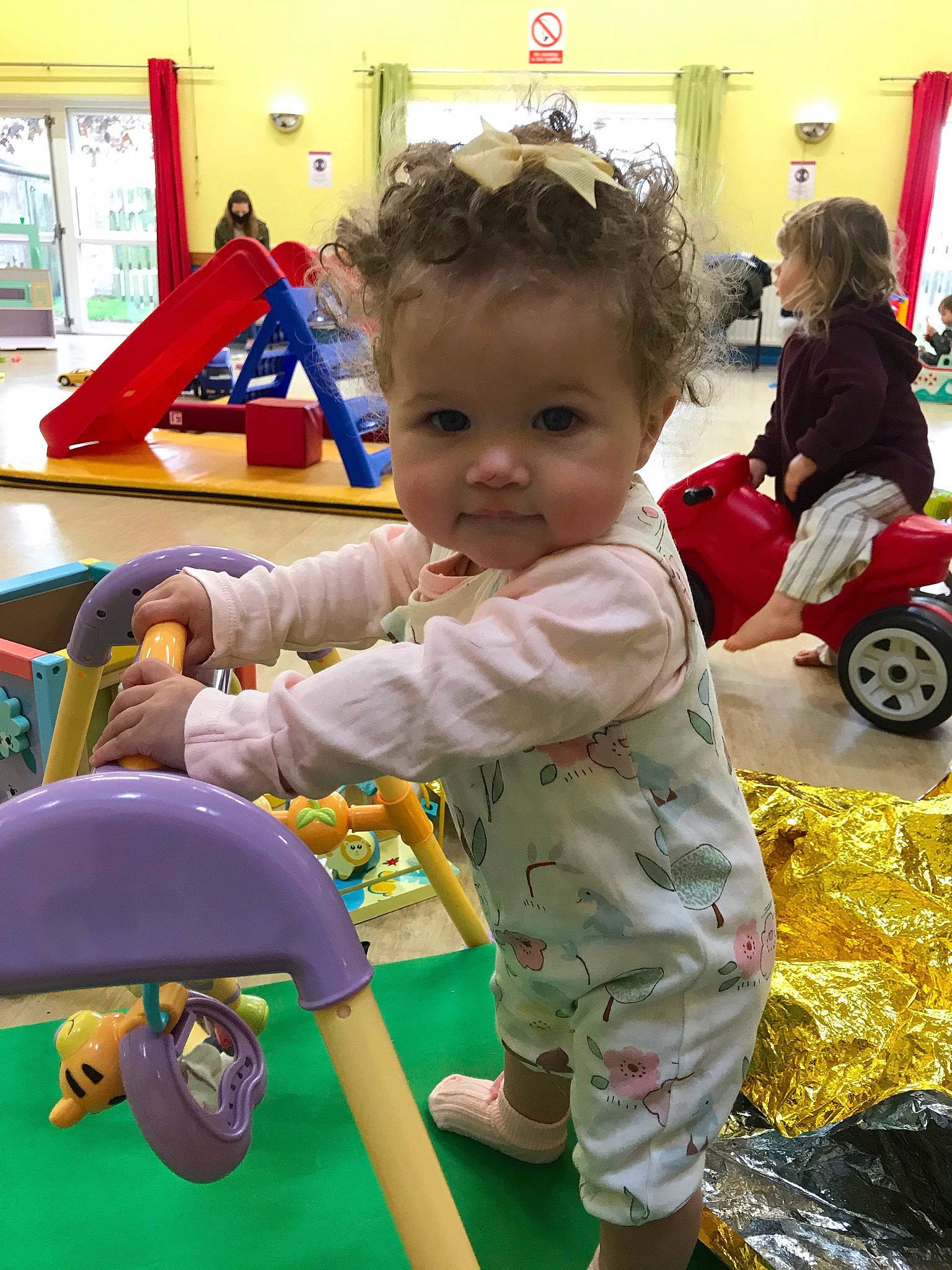 Adelaide is registered to the contest to win money with this photo: baby, baby_playing_with_toys, baby_toddler_clothing, blurred, child, event, facial_expression, fun, happy, head, leisure, person, photograph, recreation, smile, snapshot, standing, tire, toddler, toy