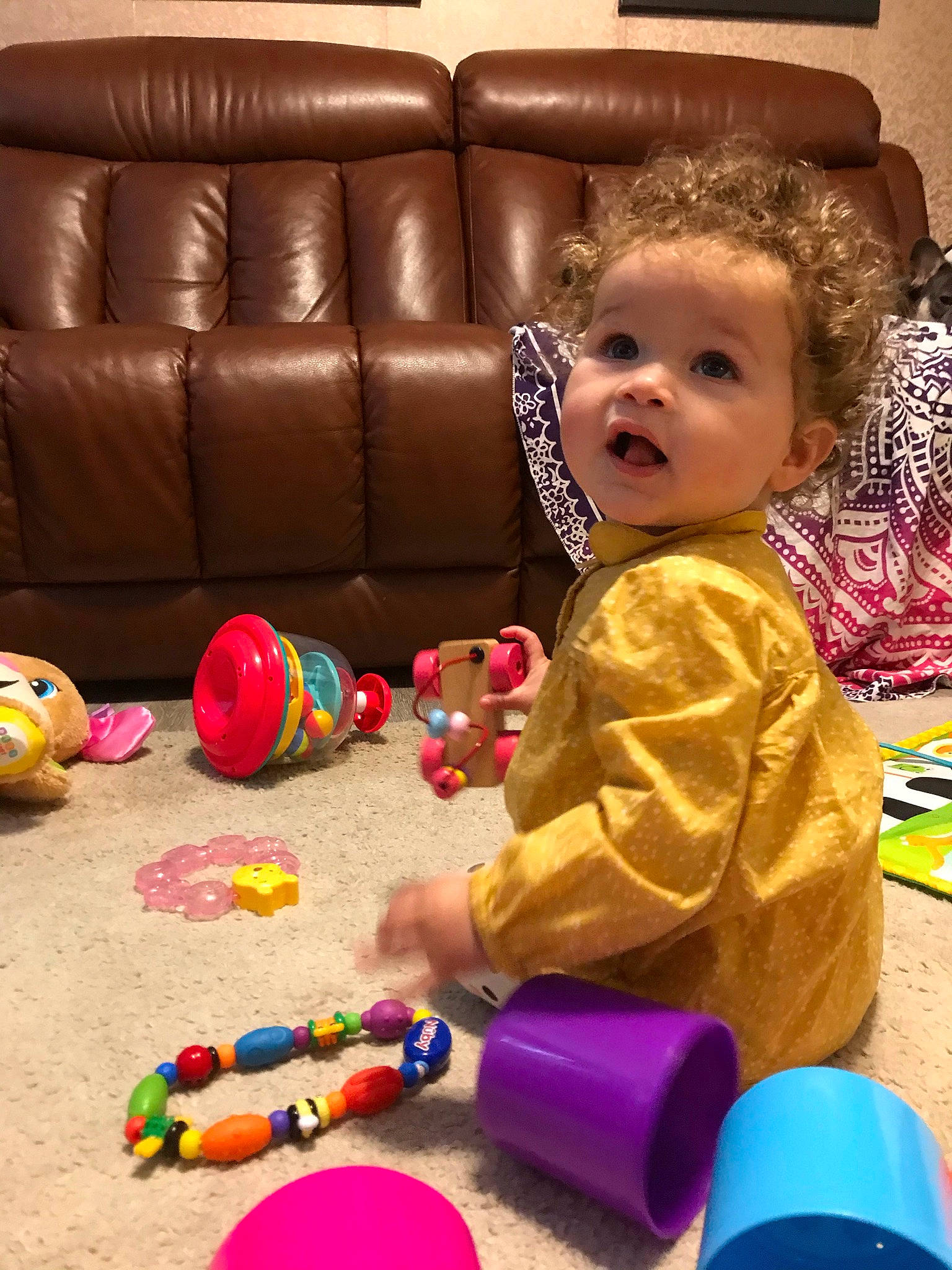 Adelaide joined the competition — help win amazing prizes! baby, baby_playing_with_toys, baby_toys, blue, child, comfort, couch, event, floor, flooring, fun, hardwood, leisure, person, product, room, sitting, smile, surprise, toddler