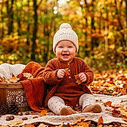 Laz joined the competition — help win amazing prizes! baby, child, autumn, forest, outdoor, knit_hat, sweater, blanket, pumpkin, fallen_leaves, smiling, sitting, portrait, nature, woodland, fall_colors, basket, cozy, infant, photography