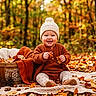 baby, child, autumn, forest, outdoor, knit_hat, sweater, blanket, pumpkin, fallen_leaves, smiling, sitting, portrait, nature, woodland, fall_colors, basket, cozy, infant, photography