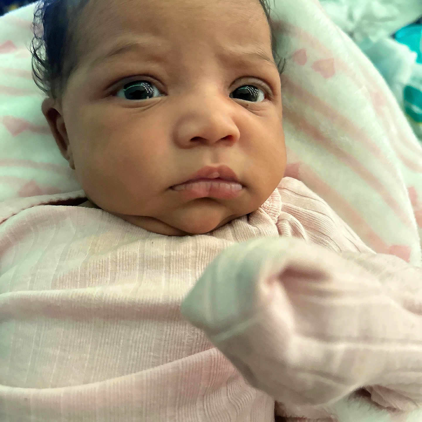 Kelaiah joined the competition — help win amazing prizes! baby, blanket, child, close_up, clothing, curly_hair, cute, expression, eyes, face, indoor, infant, newborn, person, pink, portrait, skin, soft_texture, wrapped, young