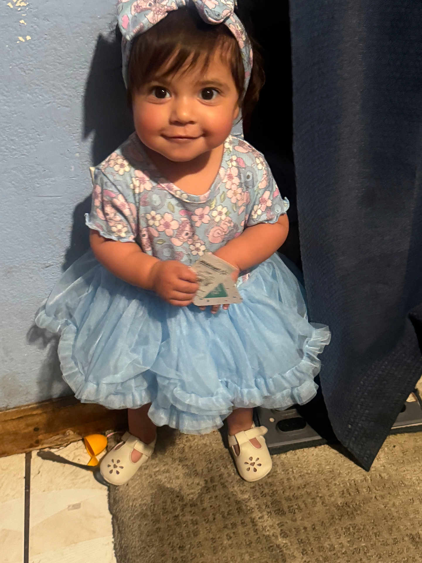Dalayza joined the competition — help win amazing prizes! toddler, child, girl, dress, headband, smile, indoors, carpet, curtain, wall, floor, shoes, toy, card, person, cute, happy, standing, clothing, portrait