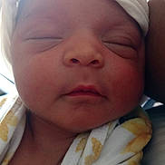 A'Nyra is registered to the contest to win money with this photo: baby, newborn, infant, sleeping, close_up, face, headwrap, blanket, soft_light, peaceful, wrapped, child, portrait, indoors, cozy, cute, skin, human, young, resting
