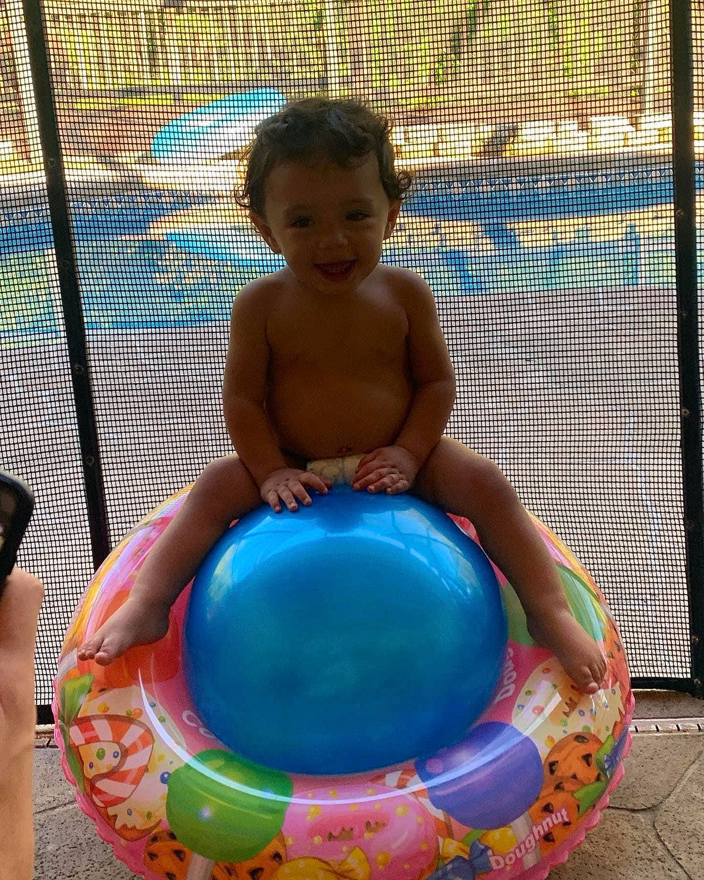 Jr is registered to the contest to win money with this photo: art, baby_products, barechested, barefoot, bathing, blue, child, circle, electric_blue, fence, foot, fun, joy, leisure, mesh, person, play, recreation, sitting, toddler