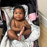 Yahxhari joined the competition — help win amazing prizes! baby, infant, car_seat, blanket, diaper, curly_hair, smiling, happy, indoors, floor, wooden_floor, black_hair, cute, child, person, skin, foot, hand, seat, soft