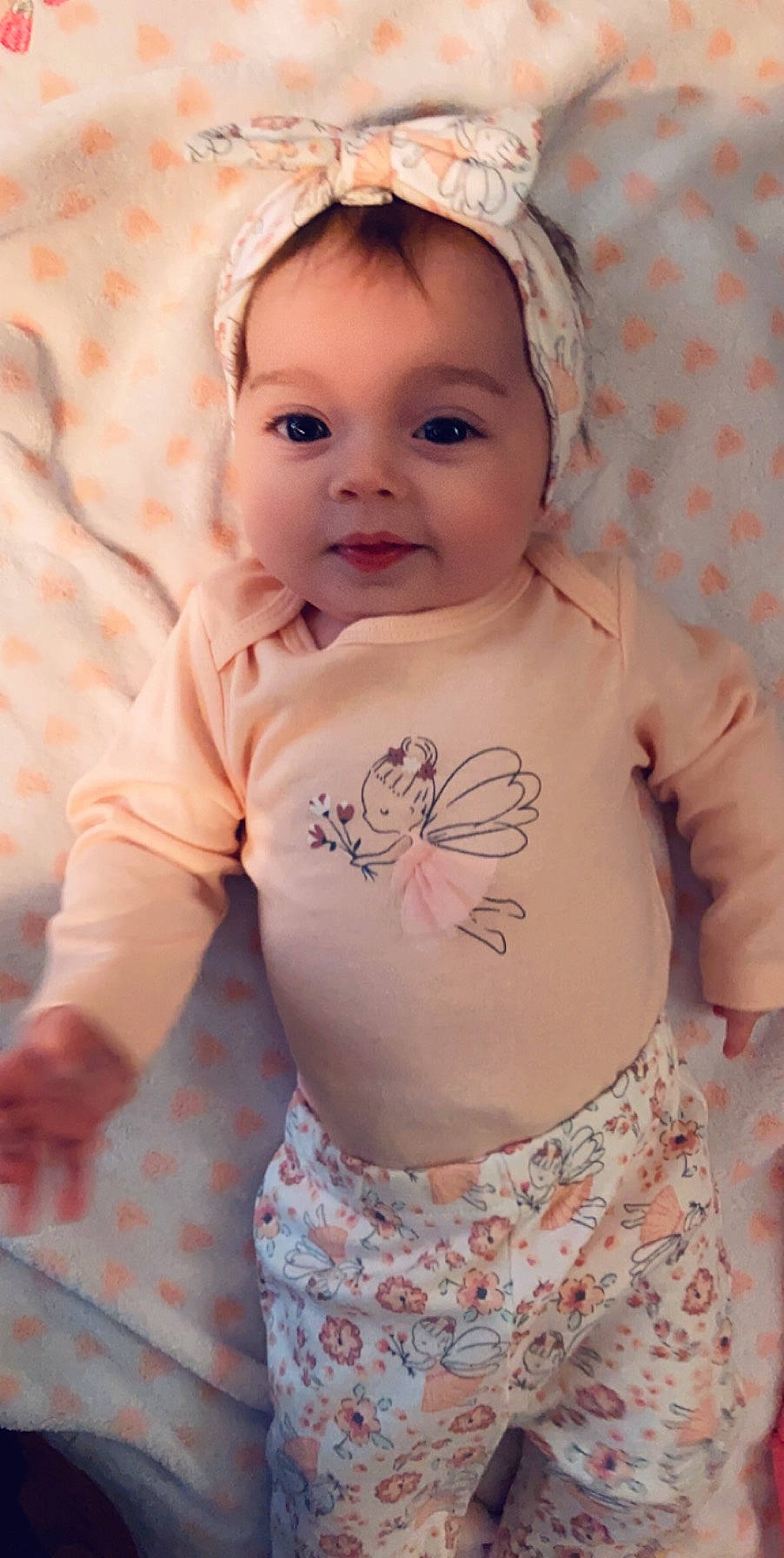 Rosalina is registered to the contest to win money with this photo: baby, baby_products, baby_toddler_clothing, cheek, child, face, head, pattern, peach, person, pink, product, skin, sleeve, smile, toddler