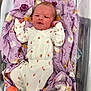 Alexis joined the competition — help win amazing prizes! newborn, baby, infant, hospital, bassinet, blanket, purple, floral, clothing, strawberry, cute, sleepwear, person, lying_down, indoors, soft, small, newborn_clothes, footwear, baby_shoes