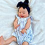 Holland is registered to the contest to win money with this photo: baby, infant, smiling, headband, bow, romper, bracelet, hand, foot, blanket, happy, cute, child, lying_down, soft_texture, patterned_clothing, skin, portrait, playful, young