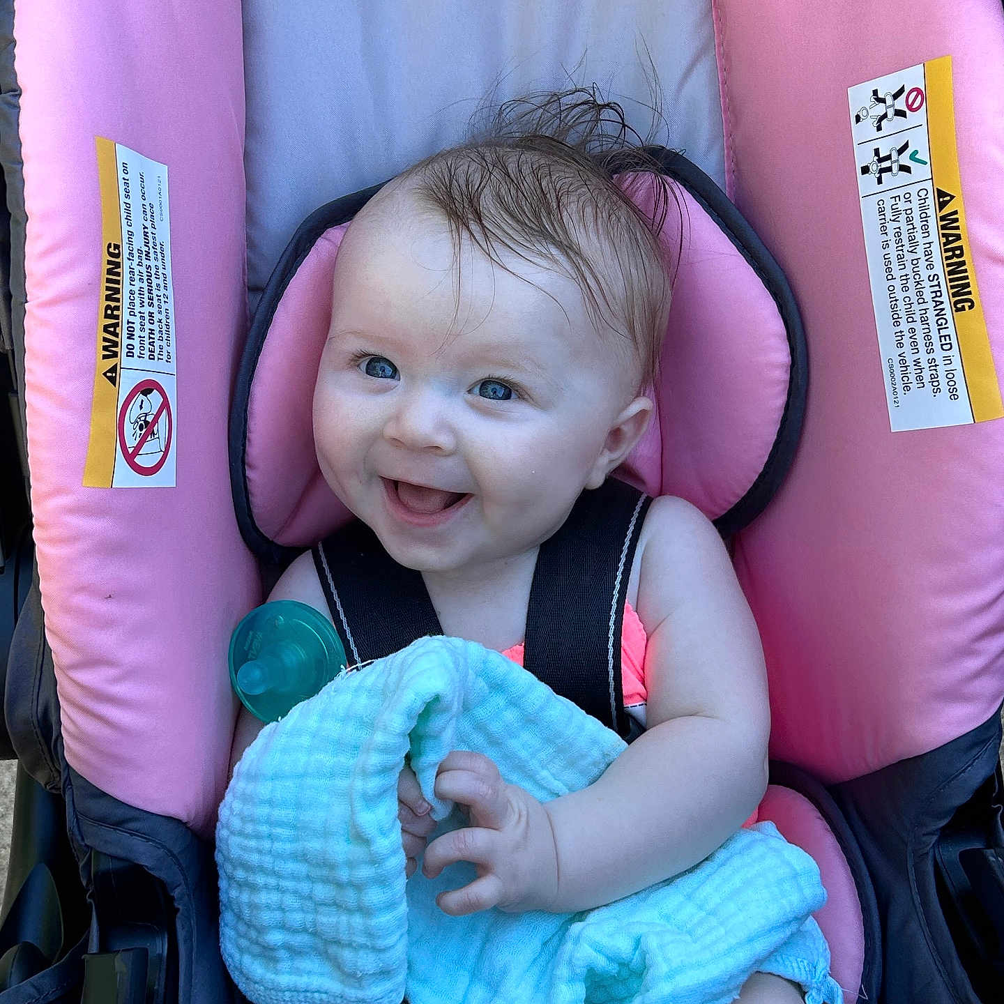 Emily joined the competition — help win amazing prizes! baby, child, car_seat, pink, blanket, pacifier, smiling, happy, blue_eyes, hair, infant, seatbelt, cute, toddler, person, portrait, indoors, clothing, baby_toy, expression