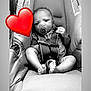 Kenzo is registered to the contest to win money with this photo: baby, car_seat, pacifier, infant, black_and_white, heart_emoji, straps, cute, child, sitting, footwear, clothing, indoor, portrait, young, safety, seat, expression, head, legs