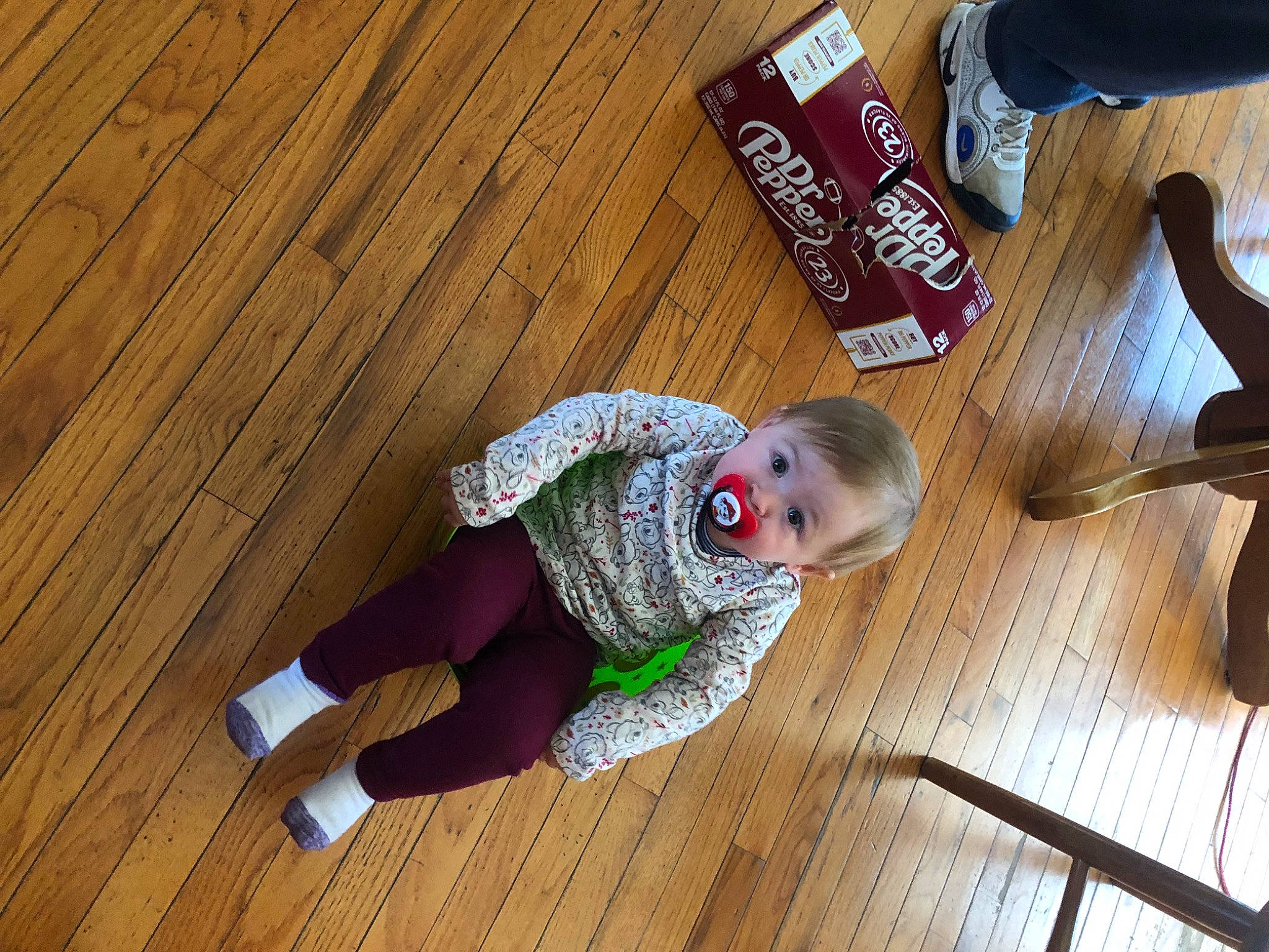 Avory is registered to the contest to win money with this photo: aluminum_can, baby, baby_toddler_clothing, child, floor, flooring, foot, hardwood, laminate_flooring, pattern, person, plank, plywood, sitting, sleeve, surprise, tin_can, toddler, varnish, wood