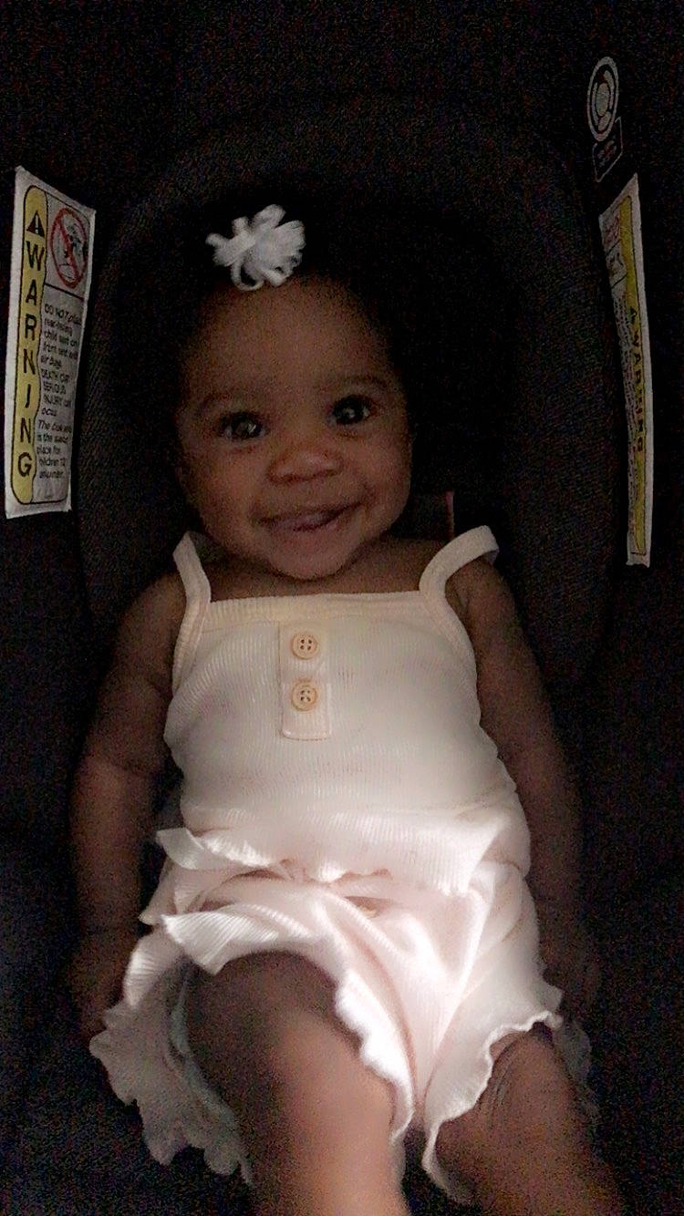 Laylani is registered to the contest to win money with this photo: baby, baby_toddler_clothing, cheek, chest, chin, comfort, dress, eye, eyebrow, flash_photography, happy, head, human_body, iris, joy, lip, person, skin, smile, thigh