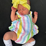 Emereigh is registered to the contest to win money with this photo: baby, sleeping, headband, yellow, bow, dress, striped, colorful, white_socks, infant, child, cute, peaceful, resting, newborn, portrait, clothing, fabric, skin, texture