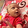 baby, infant, child, red_clothing, onesie, polka_dots, hand, face, eyes, expression, pink_mat, animal_print, cute, looking_up, indoor, soft_light, skin, newborn, person, playful