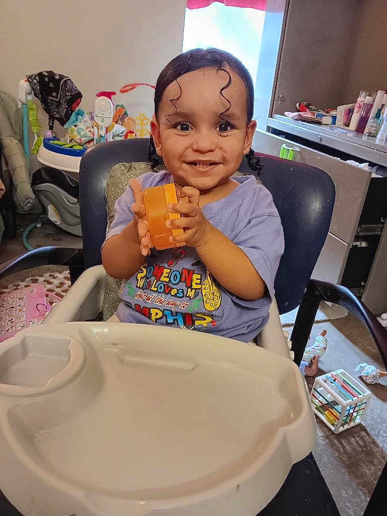 Jaeluv joined the competition — help win amazing prizes! toddler, child, smiling, high_chair, toy, indoor, curly_hair, baby, happy, person, furniture, play, room, clothing, seat, table, face, hand, expression, home