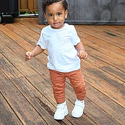 Winston joined the competition — help win amazing prizes! toddler, child, white_tshirt, orange_pants, white_sneakers, wooden_deck, outdoor, walking, curly_hair, smiling, person, young_child, cute, casual_clothing, daylight, standing, portrait, happy, small_child, fun