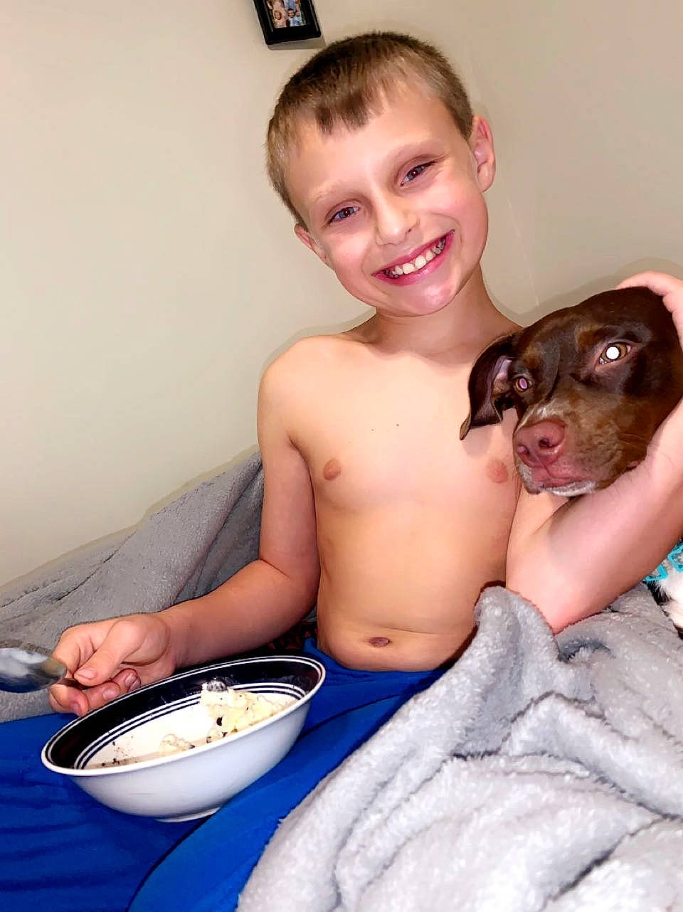 Bentlee is registered to the contest to win money with this photo: barechested, bathing, carnivore, chest, companion_dog, cuisine, dish, dog, dog_breed, fawn, food, happy, joy, muscle, person, plate, selfie, sitting, smile, tableware