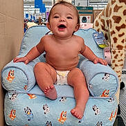 Paisley joined the competition — help win amazing prizes! armchair, baby, barefoot, bluey, child, diaper, furniture, giraffe, happy, indoor, infant, laughing, plush_toy, portrait, price_tags, retail_store, shopping, sitting, smiling, toy_store
