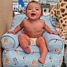 baby, child, infant, smiling, sitting, armchair, bluey, plush_toy, giraffe, toy_store, retail_store, indoor, shopping, portrait, happy, laughing, diaper, barefoot, furniture, price_tags