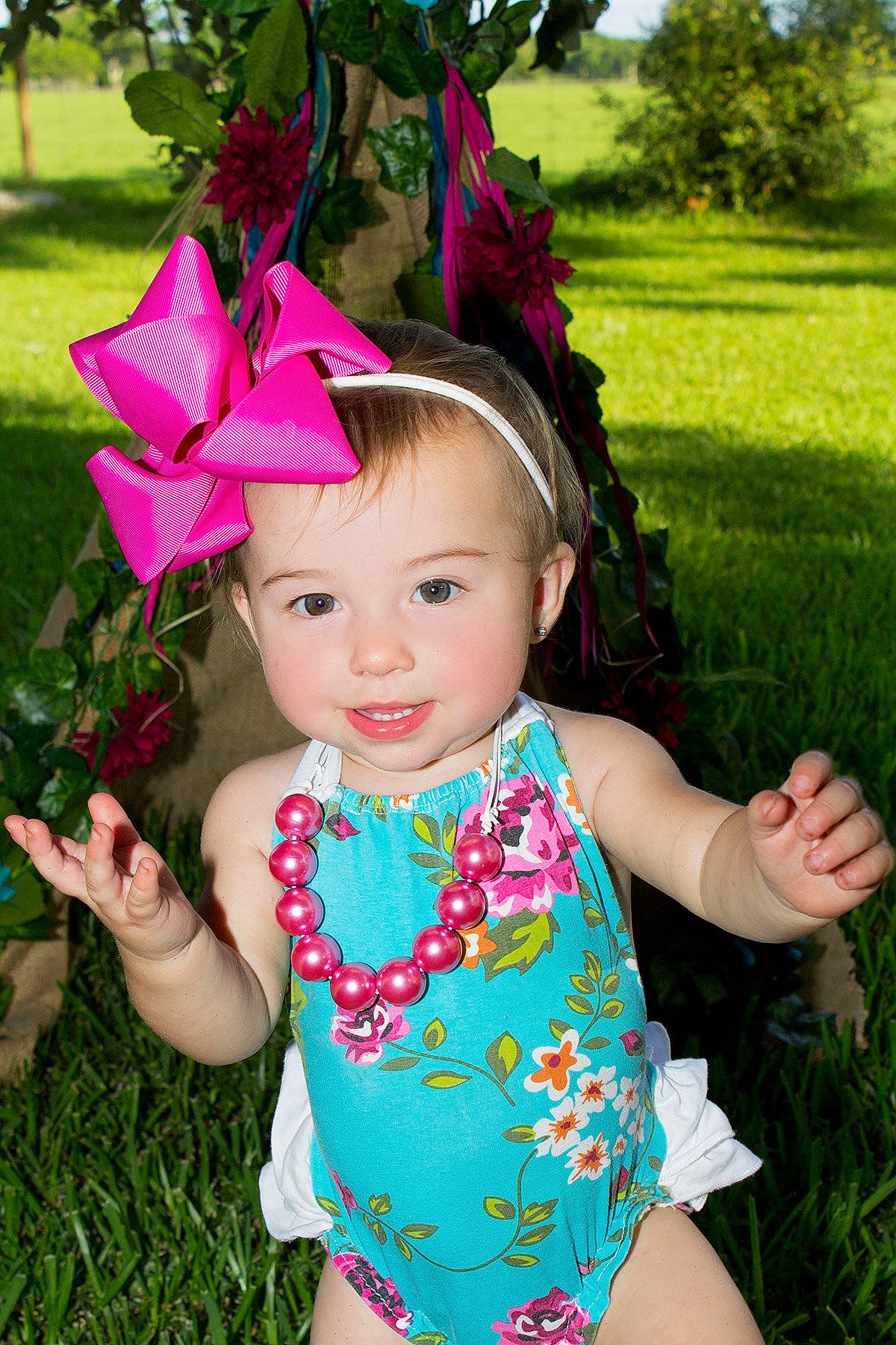 Kynzlee joined the competition — help win amazing prizes! baby, child, clothing, costume, costume_accessory, costume_hat, fashion_accessory, flower, grass, hair_accessory, hat, headgear, magenta, person, pink, plant, smile, toddler