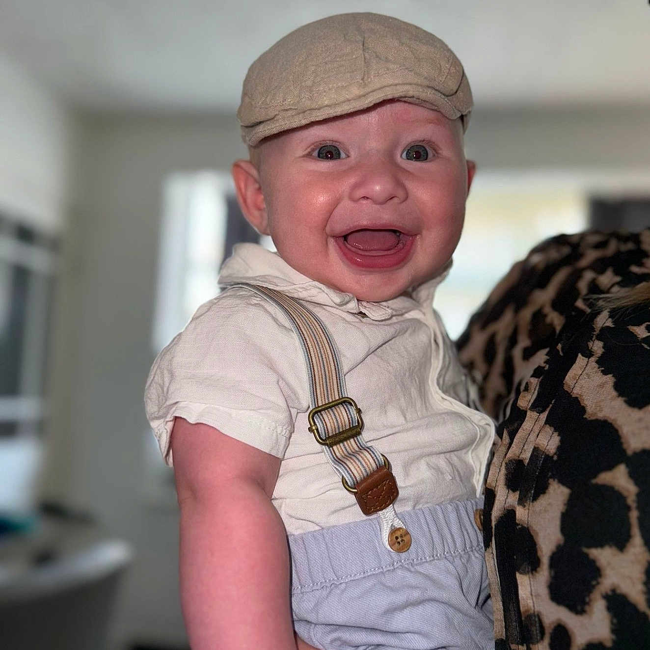Nate joined the competition — help win amazing prizes! baby, background, button, cap, cheerful, child, clothing, cute, face, hand, happy, holding, indoor, infant, person, portrait, shorts, skin, smiling, suspenders