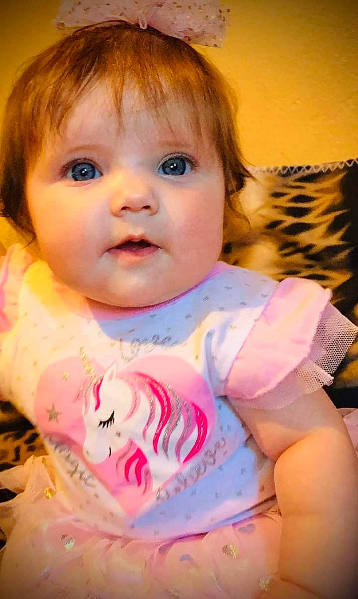 Masaya joined the competition — help win amazing prizes! baby, baby_toddler_clothing, bib, cheek, child, chin, dress, eye, eyebrow, eyelash, happy, head, iris, lip, mouth, nose, person, pink, skin, sleeve