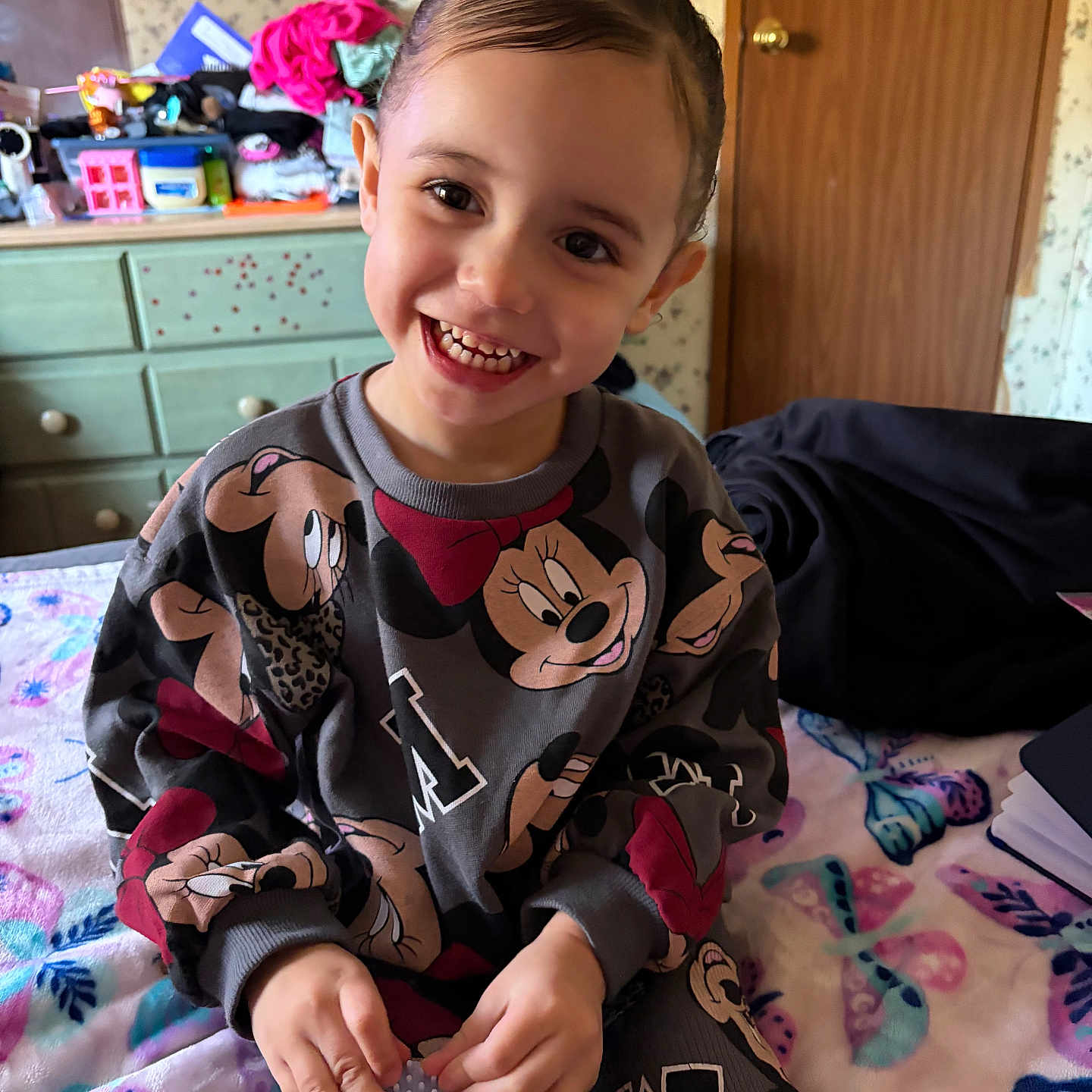 Nylah Bland joined the competition — help win amazing prizes! bed, blanket, child, clothing, cute, door, dresser, face, furniture, hair, hand, happy, indoor, pattern, person, playful, room, sitting, smiling, toy