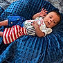 Sebastian joined the competition — help win amazing prizes! baby, infant, child, blanket, blue_blanket, clothing, shorts, tshirt, red_stripes, stars, patriotic, cute, lying_down, hand, foot, face, expression, indoor, soft_texture, person