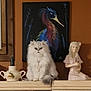 animal, art, bird_painting, cat, cute, decor, expression, feline, fluffy, furniture, home, indoor, ornament, painting, pet, porcelain_figurine, shelf, sitting, still_life, white_cat