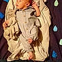 Rylan is registered to the contest to win money with this photo: baby, infant, blanket, plush_toy, onesie, star, decorations, text, letters, soft_toy, child, cute, sleeping_area, fabric, comfort, indoor, colorful, gaze, lying_down, cozy
