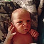 Rylan is registered to the contest to win money with this photo: baby, newborn, infant, face, hand, blanket, skin, expression, curious, closeup, portrait, soft, pattern, young, child, person, human, resting, indoors, newborn_baby