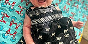 Sophia is registered to the contest to win money with this photo: baby, smiling, black_dress, butterfly_pattern, blanket, colorful, dr_seuss, infant, happy, lying_down, indoors, cute, child, clothing, pattern, person, portrait, small_hands, cheerful, fabric
