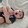 Christian joined the competition — help win amazing prizes! baby, infant, child, foot, hand, face, expression, clothing, onesie, white_background, soft_surface, lying_down, happy, curious, skin, human, cute, indoors, portrait, young