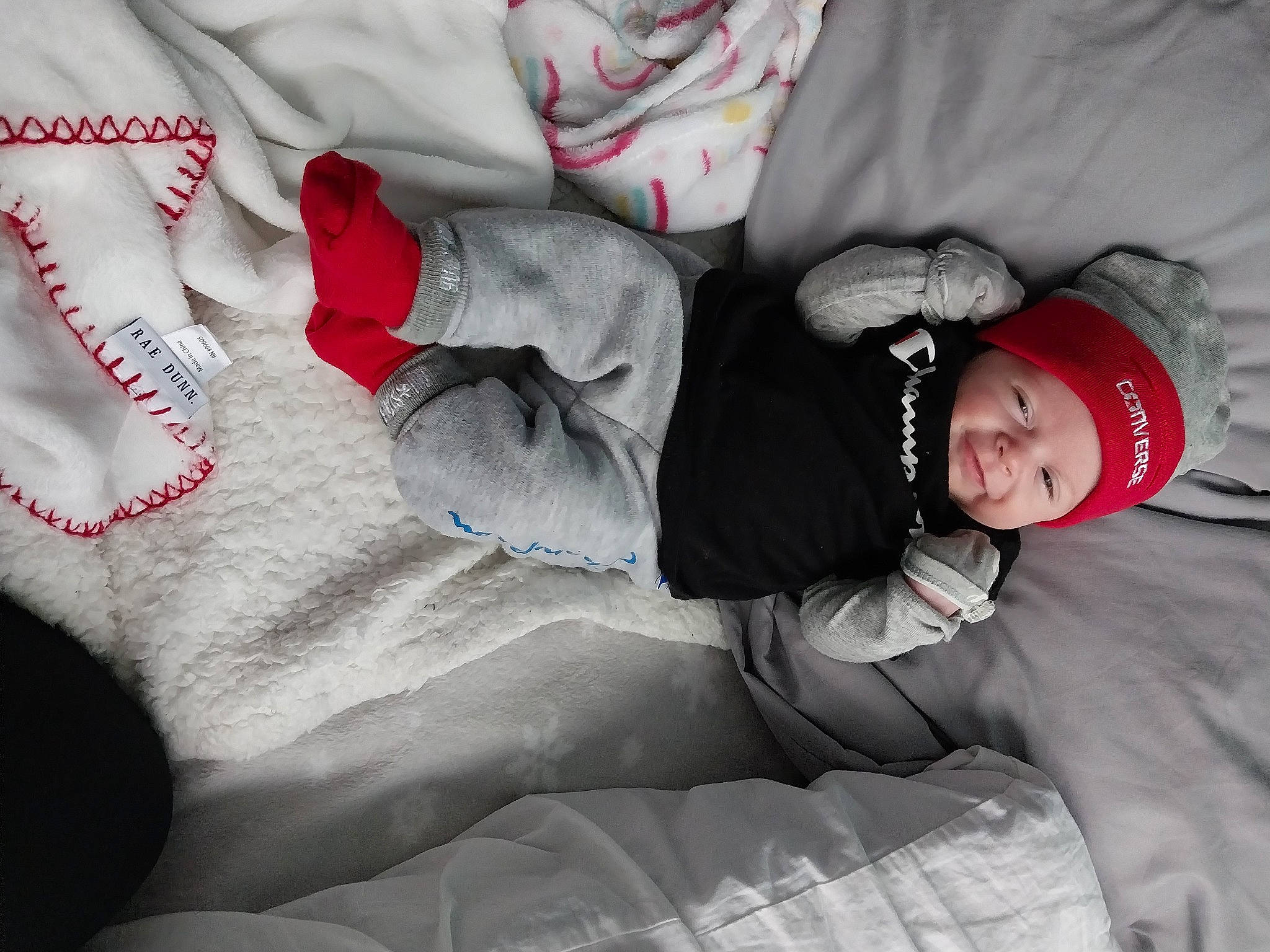 Brinleigh is registered to the contest to win money with this photo: arm, beauty, child, comfort, face, facial_expression, finger, flash_photography, gesture, grey, hand, headwear, human_body, leg, linens, mouth, person, sleeve, textile, thigh