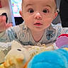 Aylan participe au concours pour gagner de l'argent avec cette photo : baby, child, toys, indoor, curious, wide_eyes, colorful, soft_lighting, face, person, clothing, playtime, cute, young, crawling, home, background, television, expression, infant