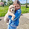 Bucky participe au concours pour gagner de l'argent avec cette photo : child, dog, puppy, girl, denim_jacket, outdoor, green_grass, flowering_trees, blue_sky, sunny, cute, pet, smiling, nature, holding, happy, portrait, animal, grass, spring
