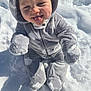 baby, child, cozy, cute, hood, infant, mittens, onesie, outdoor, playful, plush, portrait, rosy_cheeks, sitting, smile, snow, snowy_background, sunlight, tongue_out, winter