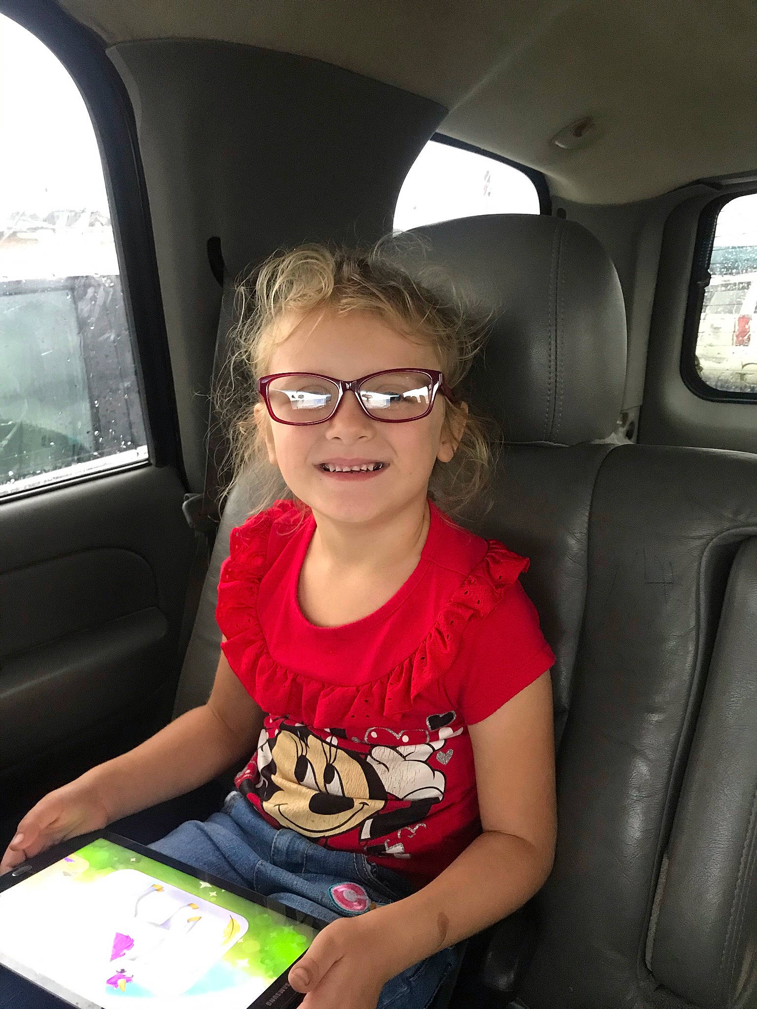 Olivia is registered to the contest to win money with this photo: auto_part, automotive_design, automotive_exterior, beauty, car, car_seat, car_seat_cover, eyewear, finger, fun, gadget, glasses, head_restraint, joy, light, motor_vehicle, person, smile, steering_wheel, toddler