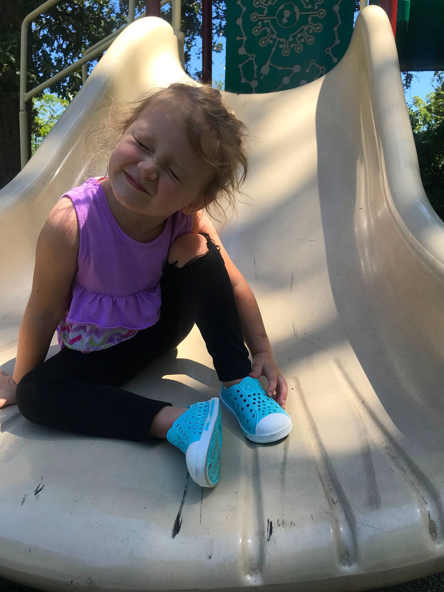 Olivia is registered to the contest to win money with this photo: fun, joy, leisure, outdoor_play_equipment, person, playground, playground_slide, recreation, smile, vacation