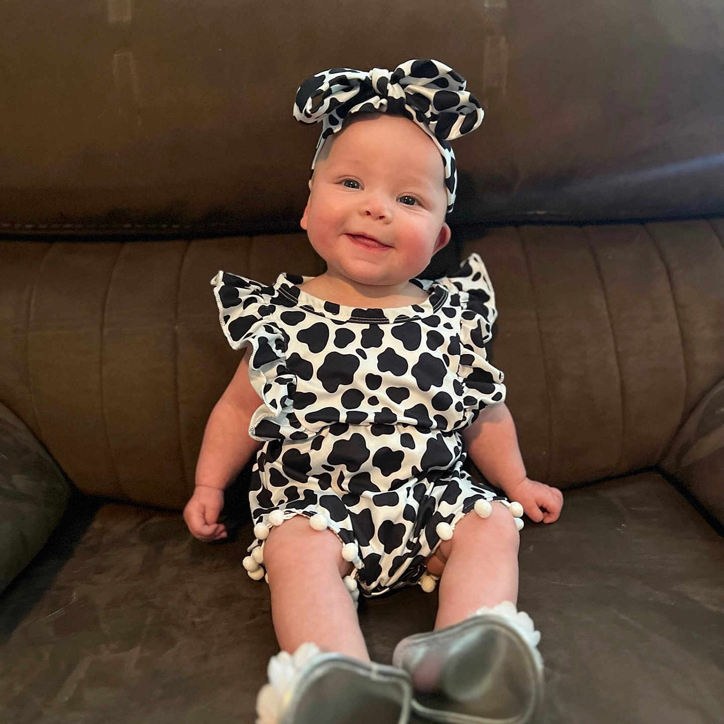 Raelynn is registered to the contest to win money with this photo: architecture, baby, clothing, couch, cushion, dress, face, footwear, furniture, happy, hat, head, homedecor, pants, person, photography, pillow, portrait, shoe, sitting