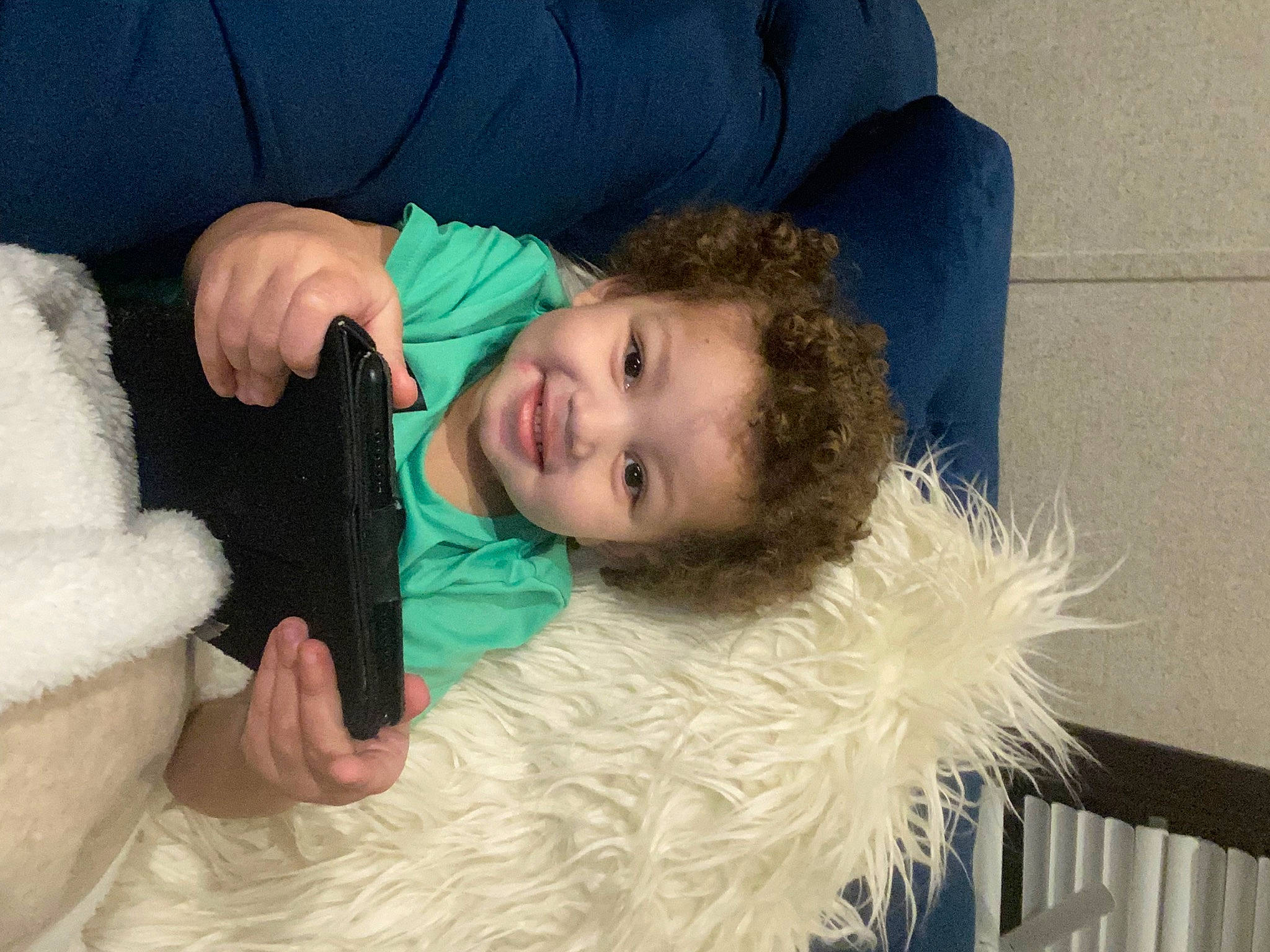 Elijah is registered to the contest to win money with this photo: child, comfort, couch, electric_blue, eye, face, feather_boa, fun, fur, fur_clothing, gesture, hair, happy, head, joy, nose, person, shoulder, sitting, skin